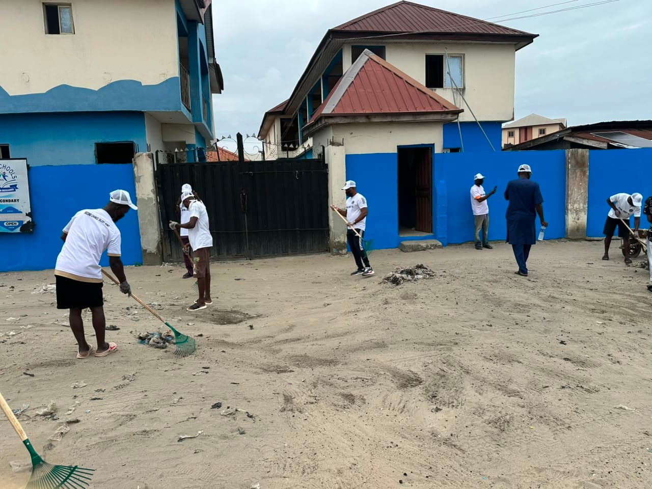 Squad ambassadors and local residents joining forces for environmental hygiene ahead of the Second Chance Talent Hunt in Ajegunle.